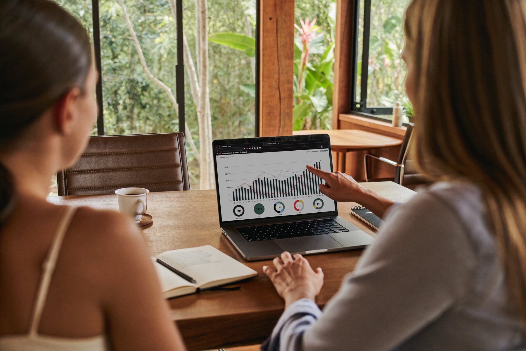 Reviewing numbers together at a laptop.